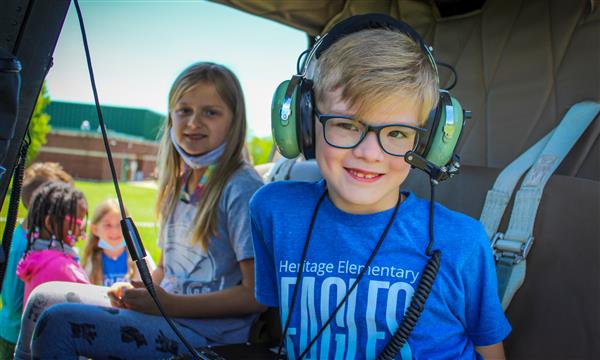 Students sit in helicopter